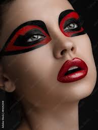 red lips black makeup on the eyes of