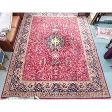 a red ground grosvenor wilton rug with