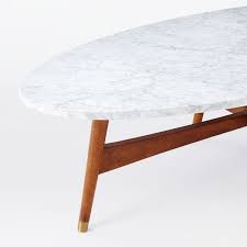 A marble coffee table usually consists of a marble top with various other materials and designs for its base. Reeve Mid Century Oval Coffee Table Marble Top