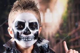 scary little boy wearing skull makeup