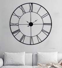 black color metal wall clock by