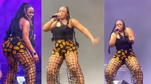 yemi alade reacts as she performs