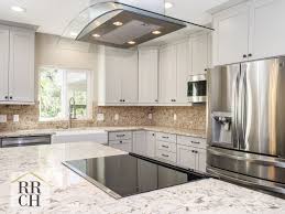 I'm taking up the floors and we're replacing the countertops and i don't know where to start first; Waypoint Cabinets In Harbor Color With Oil Rubbed Bronze Hrdware And Montclair White Quartz Cou Brick Backsplash Kitchen Kitchen Design White Quartz Countertop