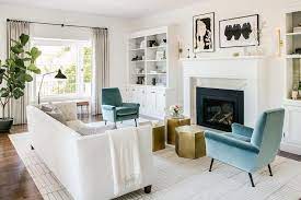 white sofa with blue velvet chairs