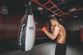 muscular man playing punching bag