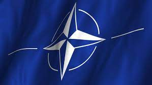 The flag of the north atlantic treaty organization (nato) consists of a dark blue field charged with a white compass rose emblem, with four white lines radiating from the four cardinal directions. A Beautiful Satin Finish Looping Stock Footage Video 100 Royalty Free 2647700 Shutterstock