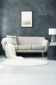 sofa by dark grey wall stock photo by