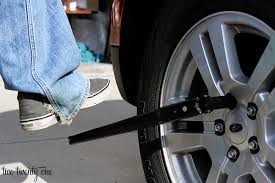 Image result for undoing wheel nuts standing on wheel brace