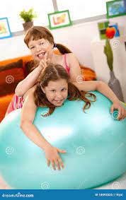 Schoolgirl Teasing Friend on Gym Ball Stock Image - Image of cheerful,  blue: 18493325