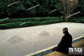 Buddhist Monk Meditating In Front Of A