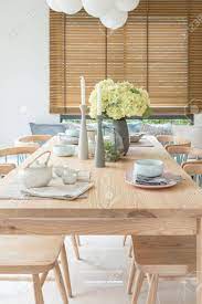 Maybe you would like to learn more about one of these? Wooden Dining Table In Modern Dining Room With Table Set And Vase Of Plants Interior Design Concept Stock Photo Picture And Royalty Free Image Image 80198552
