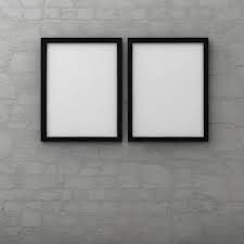 Two Empty Frames Hang On A Brick Wall