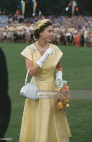 Queen Elizabeth II holds a bouquet of flowers as she waves to crowds... |  Queen elizabeth ii wedding, Queen elizabeth, Elizabeth queen of england