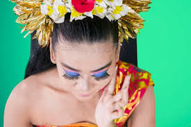 pretty balinese dancer applying makeup
