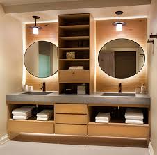 a double sink vanity with wood shelves