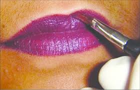 thin layer of lipstick with a brush