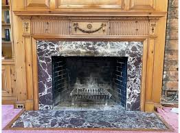 An Antique Mantle And Marble Fireplace