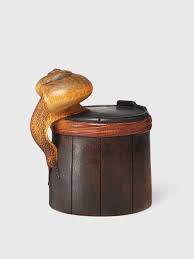 Containers called sagemono—pouches, woven baskets. A Wood Netsuke Of A Snail On A Bucket
