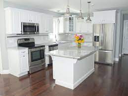 White stainless steel appliances can be a beautiful accompaniment to your elegant design. Gorgeous Modern Kitchen With White Cabinets Stainless Steel Appliances Stainless Pendant Lighting Over Th Kitchen Remodel Small Kitchen Design Kitchen Layout
