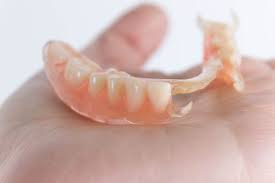 a dental bridge vs dentures which is
