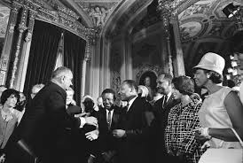the civil rights act of and the voting rights act of  black and white photograph of lyndon johnson extending a hand to martin luther king jr