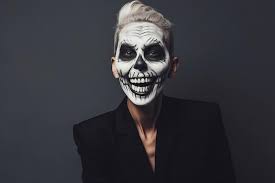 young man with skull makeup isolated on
