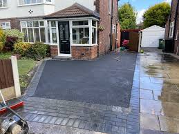 When a concrete driveway is being installed forms are used to contain the concrete so once the concrete is dry, it creates that straight edge. Tarmac Driveway With Charcoal Brick Edging In Didsbury Fcd Driveways