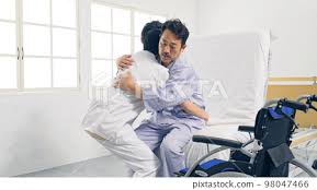 caregiver isting transfer from bed