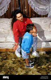 Hispanic mother spanks son Stock Photo - Alamy