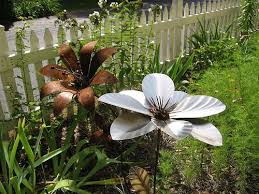 If your yard is looking a little unexciting and lacking in character, it could be time for you to add the promise of warm weather and blooming flowers. Metal Flowers Metal Garden Art Garden Art Metal Flowers Garden