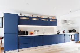 Deep rich blue cabinets with white farmhouse sink, white subway tile backsplash and white walls/ceiling. Best Kitchens In Classic Blue Try Out The Trendiest Color In Many Tones