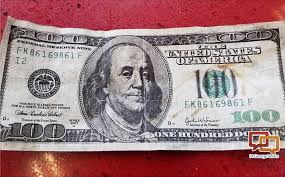 counterfeit 100 bills being ped in