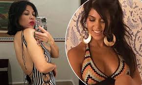 Kourtney Kardashian looks incredible in a tight striped swimsuit as she 
poses for mirror selfie