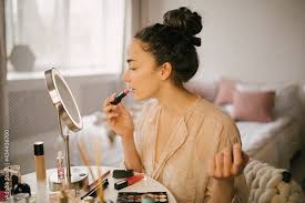 young woman applying makeup beauty