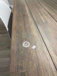 how to get white alcohol stains off wood
