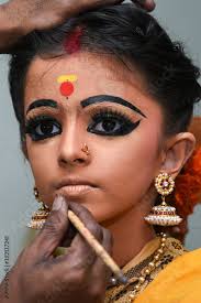 women or kid doing makeup wearing sari