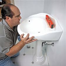 a pedestal sink with wall plumbing