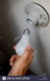 Man Changing Light Bulb Into Socket High Angle View Close