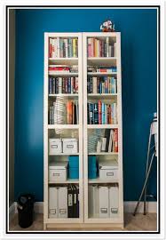 white billy bookcase and a blue wall in
