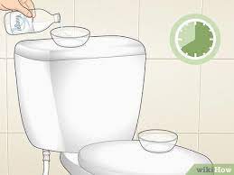 A Toilet Bowl With Vinegar And Baking Soda