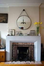 round mirror over fireplace