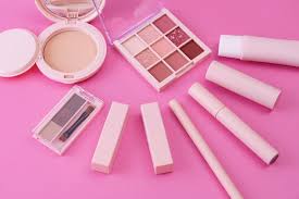 makeup tools placed on a pink background