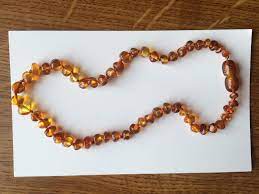 amber teething necklace embracing
