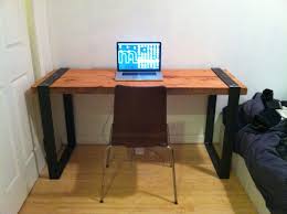 This simple computer desk is made out of unpainted wood and also water pipes which covered in a shiny coat of black paint. Industrial Reclaimed Wood And Blackened Steel Desk Diy Handmade Woodworking Desk Plans Wood Desk Design Woodworking Projects
