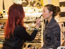 sephora makeup artist helping woman