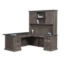A compartment hidden beneath the worksurface features a. Desks Custom Woodcraft