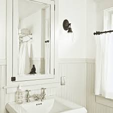 Marble tiles, black walls and white wainscoting for a refined bathroom. Beadboard Bathroom Design Ideas