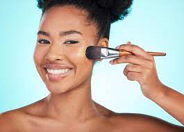 black woman foundation and brush in