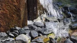 Waterfall In The Garden With Stones
