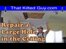 large hole in a drywall ceiling